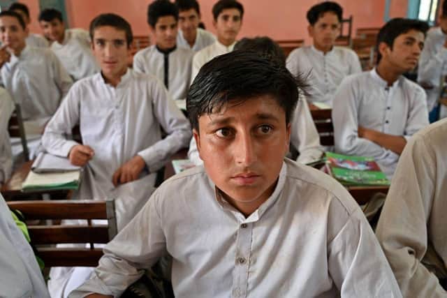 Rizwan Ullah, a survivor of the cable car accident sits in a classroom at a school in the Pashto village of mountainous Khyber Pakhtunkhwa province a day after being rescued from a chairlift which dangled over a ravine for 15 hours.