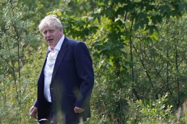 Boris Johnson walking through the grounds during the G7 summit in Schloss Elmau, in the Bavarian Alps, Germany.