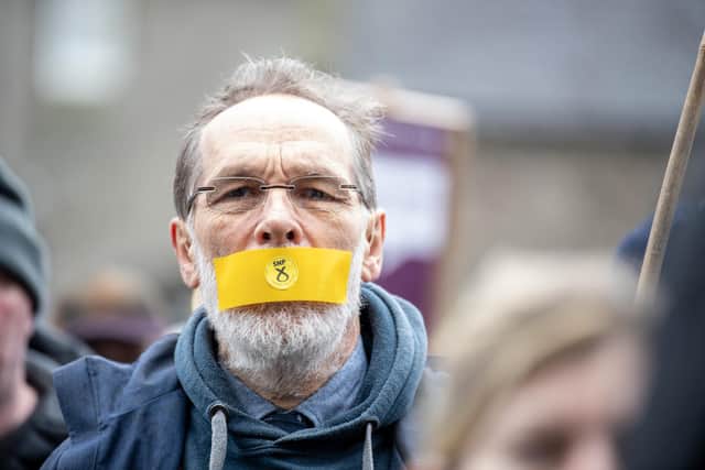 A free speech campaigner pictured during a protest outside the Scottish Parliament (Picture: Lesley Martin/PA)