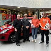 Alan Pirie, chairman of the organising committee; Gordon Arthur Irvine, milestone ticket holder, Carol McDonald from C&M McDonald and Ollie Middleton from Charlie House