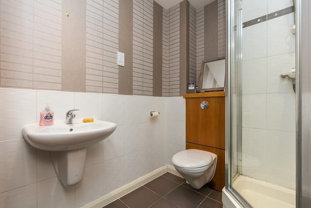 The shower room is fitted with a two-piece suite, shower cubicle, tiled splash walls, and a shaver point.