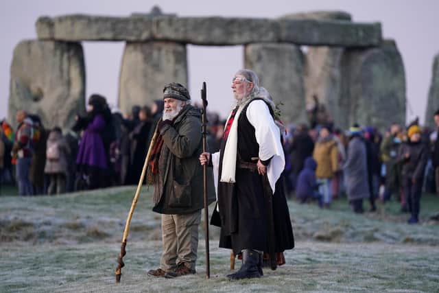 People take part in the winter solstice celebrations during sunrise at the Stonehenge prehistoric monument on Salisbury Plain in Wiltshire.