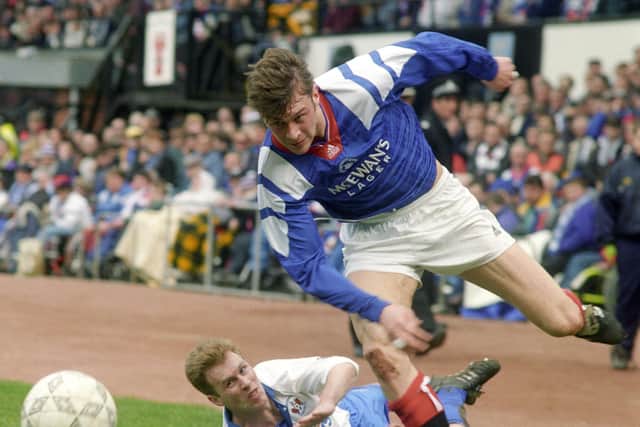 Ferguson gets the better of Mark Reilly during a match for Rangers in 1994.