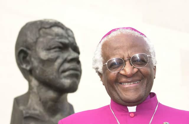 Desmond Tutu, pictured with a bust of former South African president Nelson Mandela in 2001, has died aged 90 (Picture: William Conran/PA)