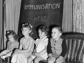 Four young children wait to be immunised against polio after a pandemic hit the UK in the 1940s and 1950s  (Photo by Terry Fincher/Getty Images)