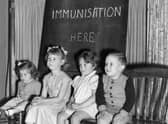 Four young children wait to be immunised against polio after a pandemic hit the UK in the 1940s and 1950s  (Photo by Terry Fincher/Getty Images)