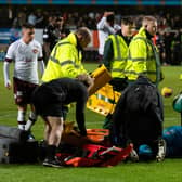 Hearts goalkeeper and captain Craig Gordon is stretchered off after coming together with Dundee United's Steven Fletcher.