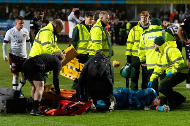 Hearts goalkeeper and captain Craig Gordon is stretchered off after coming together with Dundee United's Steven Fletcher.