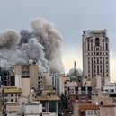 A plume of smoke rises after a strike in Tehran, Iran. 