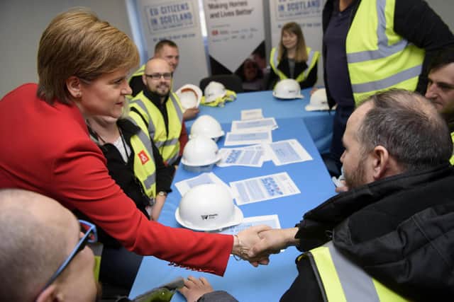 Nicola Sturgeon meets Polish and Romanian employees during a visit to a building site in Easterhouse, Glasgow, ahead of the 2019 European Parliament election (Picture: John Linton/AFP via Getty Images)