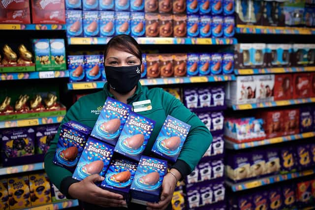 A Morrisons colleague with a donation of Easter Eggs - some of 100,000 donated to foodbanks this year. Picture: Mikael Buck