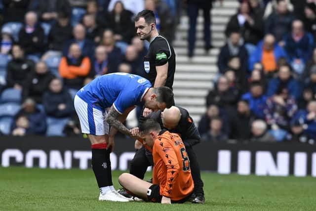 Rangers' Ryan Jack speaks to Dundee United's Peter Pawlett as he is forced off injured.