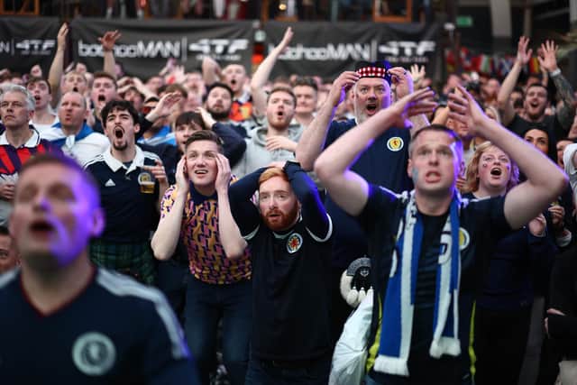 Scotland fans react as they watch the 1-1 draw with Switzerland on giant screens at the Glasgow Fan Zone. (Photo by Jeff J Mitchell/Getty Images)