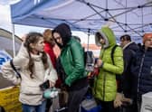 Refugees from Ukraine wait for the bus after they crossed Ukrainian-Polish border at the border crossing in Medyka, southeastern Poland.