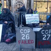 Climate activists are protesting outside a bank where they demonstrated every day during Cop26 a year ago.