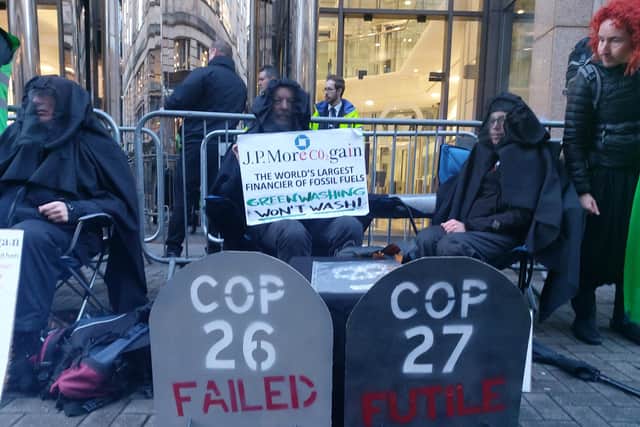 Climate activists are protesting outside a bank where they demonstrated every day during Cop26 a year ago.