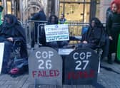 Climate activists are protesting outside a bank where they demonstrated every day during Cop26 a year ago.