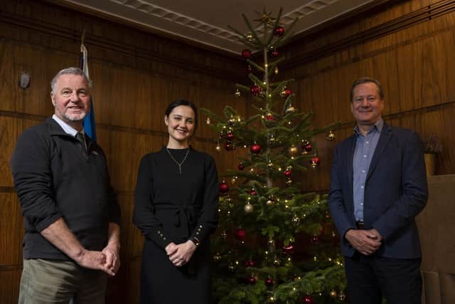 Around the Christmas tree at St Andrews House, Edinburgh are David Grieve (Highfield Forestry), Màiri McAllan and Stuart Goodall