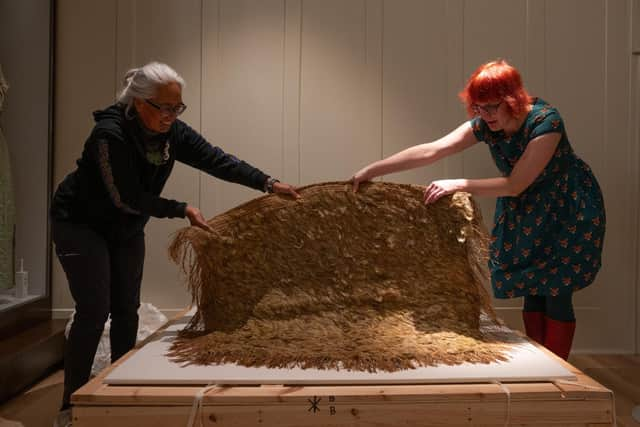 Awhina Tamarapa, teaching fellow in Museum and Heritage Studies at  Victoria University of Wellington and and Anna Zwagerman, Conservation Officer at Culture Perth & Kinross with the kākāpō cloak.