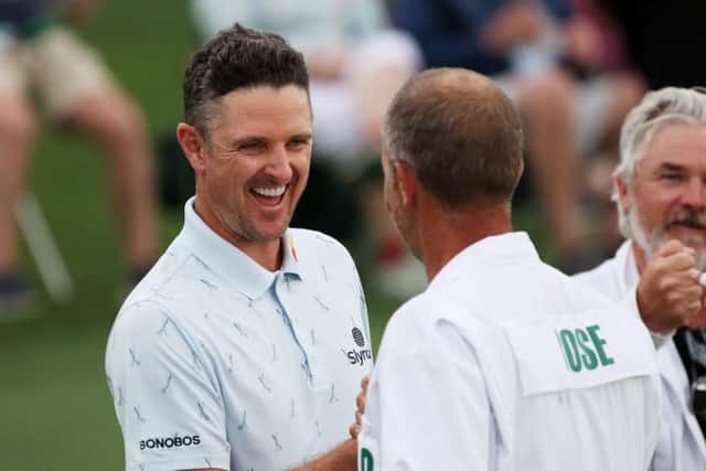 Justin Rose fist bumps his caddie, David Clark, after setting the pace in the 85th Masters at Augusta National Golf Club. Picture: Kevin C. Cox/Getty Images.