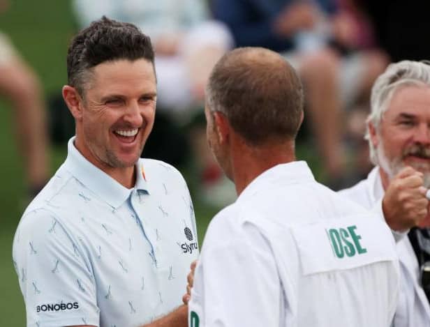 Justin Rose fist bumps his caddie, David Clark, after setting the pace in the 85th Masters at Augusta National Golf Club. Picture: Kevin C. Cox/Getty Images.