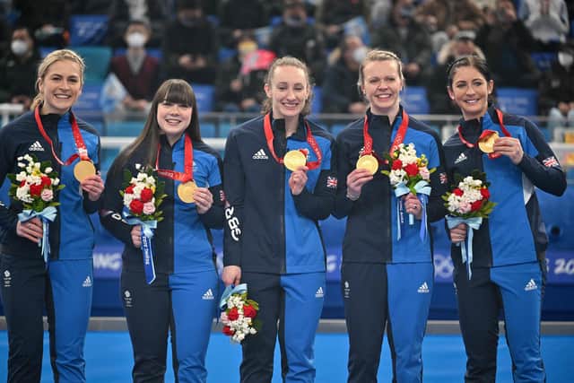 Winter Olympic curling gold medallists Britains Mili Smith, Hailey Duff, Jennifer Dodds, Vicky Wright and Eve Muirhead pose on the podium after their victory over Japan.