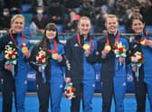 Winter Olympic curling gold medallists Britains Mili Smith, Hailey Duff, Jennifer Dodds, Vicky Wright and Eve Muirhead pose on the podium after their victory over Japan.