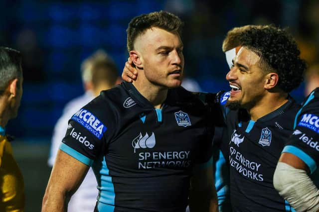 Jack Dempsey, left, is congratulated on his try against Dragons by Glasgow Warriors team-mate Sione Tuipulotu. (Photo by Craig Williamson / SNS Group)