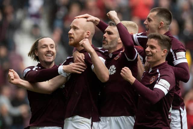 Hearts' Liam Boyce celebrates with teammates and fans after opening the scoring in his side's victory over Motherwell. Photo by Craig Foy / SNS Group