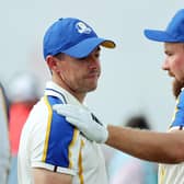 Rory McIlroy is consoled by teammate Shane Lowry as Europe crash to defeat in the Ryder Cup. (Photo by Warren Little/Getty Images)