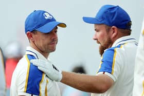 Rory McIlroy is consoled by teammate Shane Lowry as Europe crash to defeat in the Ryder Cup. (Photo by Warren Little/Getty Images)
