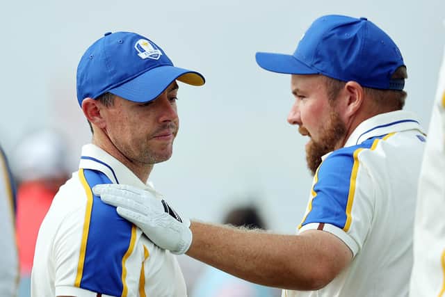Rory McIlroy is consoled by teammate Shane Lowry as Europe crash to defeat in the Ryder Cup. (Photo by Warren Little/Getty Images)