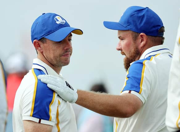 Rory McIlroy is consoled by teammate Shane Lowry as Europe crash to defeat in the Ryder Cup. (Photo by Warren Little/Getty Images)