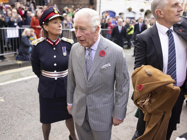 King Charles III reacts after an egg was thrown his direction