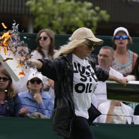 A Just Stop Oil protester runs onto Court 18 and releases confetti