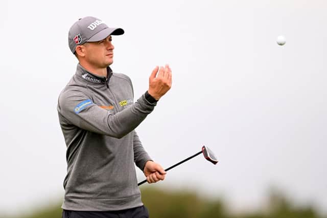 David Law throws his ball to stand-in caddie Michael MacDougall in the first round of the Hero Open at Fairmont St Andrews. Picture: Ross Kinnaird/Getty Images.