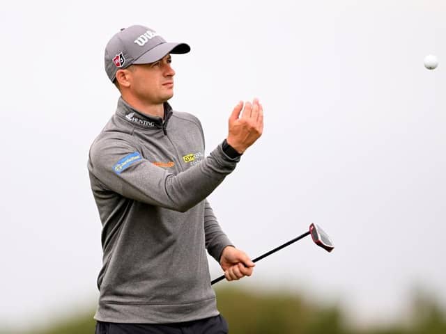 David Law throws his ball to stand-in caddie Michael MacDougall in the first round of the Hero Open at Fairmont St Andrews. Picture: Ross Kinnaird/Getty Images.