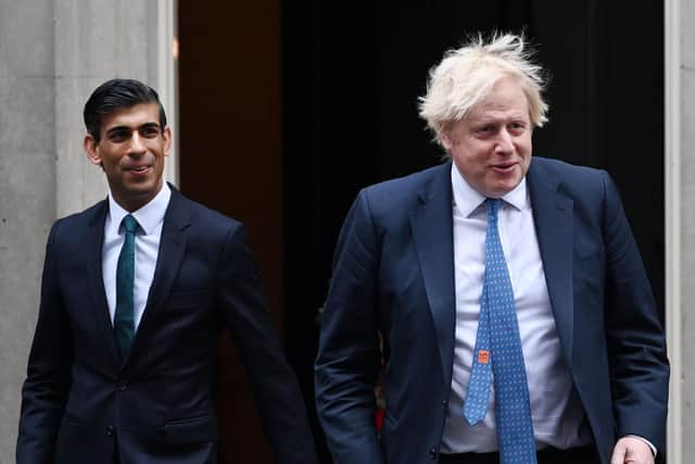 Boris Johnson (R) with  Rishi Sunak (L