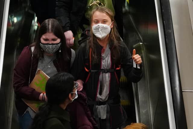 Climate activist Greta Thunberg gives a thumbs up arrives at Glasgow Central train station earlier this week ahead of the Cop26 summit.