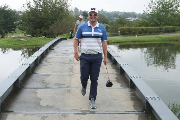 Ewen Ferguson shares a laugh as he crosses a bridge at The Club at Steyn City during the Steyn City Championship. Picture: Warren Little/Getty Images.