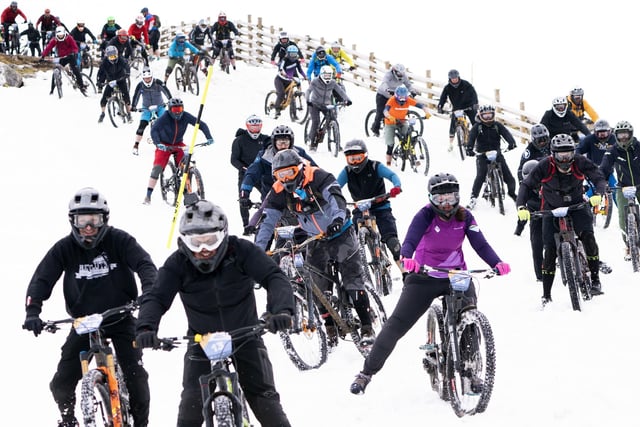Cyclists take part in MacAvalanche, a mass start mountain bike race through the snow, descending over 900m from the summit of Aonach Mor in the Nevis Range near Fort William. Picture Jane Barlow/PA Wire
