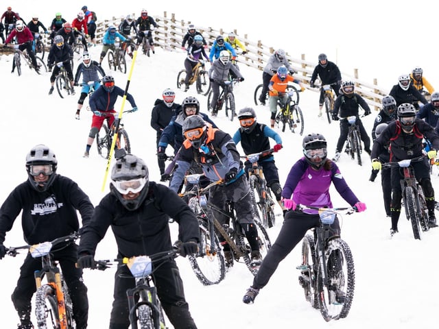 Cyclists take part in MacAvalanche, a mass start mountain bike race through the snow, descending over 900m from the summit of Aonach Mor in the Nevis Range near Fort William. Picture Jane Barlow/PA Wire