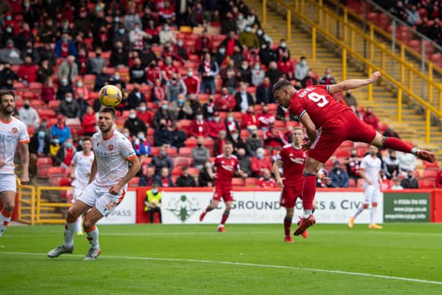 Christian Ramirez heads Aberdeen into a 2-0 lead at Pittodrie. Picture: SNS
