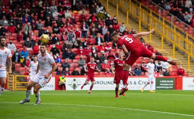 Christian Ramirez heads Aberdeen into a 2-0 lead at Pittodrie. Picture: SNS