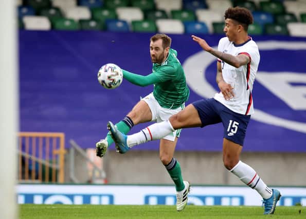 Northern Ireland's midfielder Niall McGinn (L) shoots to score their first goal during the international friendly football match between Northern Ireland and the United States at Windsor Park in Belfast on March 28, 2021. - USA won the game 2-1. (Photo by PAUL FAITH/AFP via Getty Images)