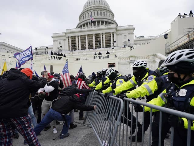Trump supporters try to break through a police barrier at the US Capitol in Washington on Wednesday last week (Picture: Julio Cortez/AP)