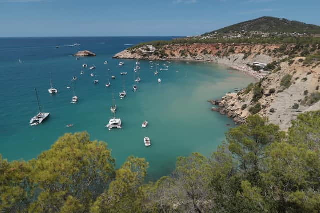 Boats lay anchored at Cala d'Hort beach on the island of Ibiza (Photo by Sean Gallup/Getty Images)