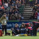 Rory Darge receives treatment after injuring his ankle in Glasgow Warriors win over Cardiff at Scotstoun. (Photo by Ross Parker / SNS Group)