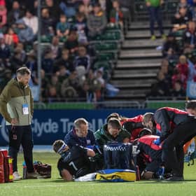Rory Darge receives treatment after injuring his ankle in Glasgow Warriors win over Cardiff at Scotstoun. (Photo by Ross Parker / SNS Group)