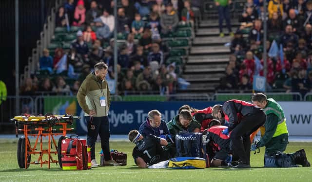 Rory Darge receives treatment after injuring his ankle in Glasgow Warriors win over Cardiff at Scotstoun. (Photo by Ross Parker / SNS Group)
